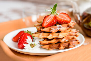 Delicious fresh baked belgian waffles with berries and fruit
