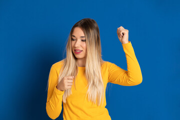 Fototapeta premium Blonde girl wearing a yellow T-shirt
