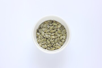Pumpkin seed in the bowl on white background