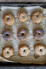 An assortment of homemade fresh bagels with different toppings. American breakfast pastry.