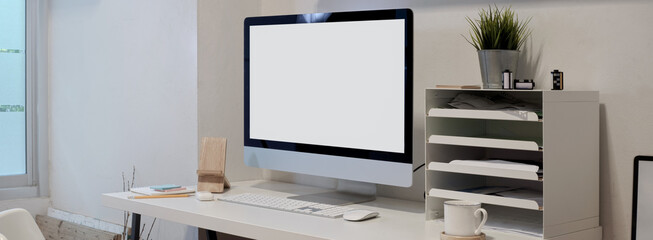 Minimal office desk with mock-up computer , office supplies and decorations on white table