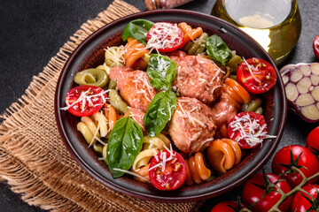 Delicious fresh pasta with meatballs, sauce, cherry tomatoes and basil