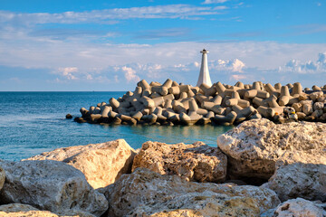 Old lighthouse in the Mediterranean sea harbor of fishing village Zygi on Cyprus on a sunny day