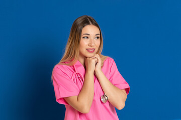 Blonde doctor with pink uniform