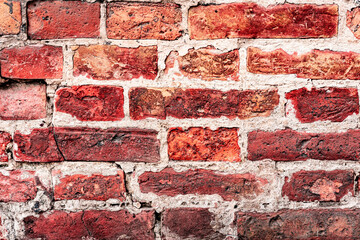 Weathered texture of stained old orange and white brick wall background