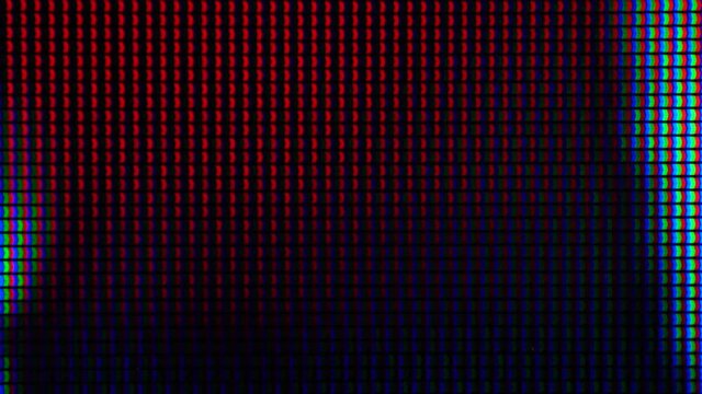 Macro shot of a computer display or TV screen. Multi-colored pixels as trace elements creating an image on an LED or LCD screen.
