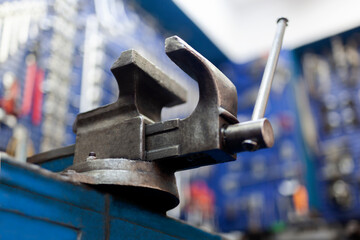 Old rusty steel clamp vise iron metal tool in the workshop workbench 