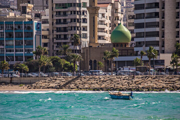 Lebanese fisherman in the boat close to the shore in Saida city, Lebanon