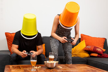 Young couple play video games sitting comfortably on the sofa at home