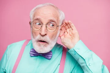 Foto op Canvas Closeup photo of attractive grandpa hand near ear listen rumors focused chatterbox bad person wear specs mint shirt suspenders violet bow tie isolated pink pastel color background © deagreez