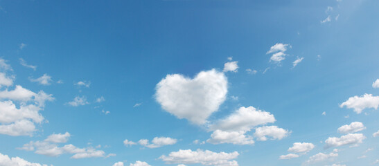 panoramic sky with flying clouds with heart shape. love romantic theme photo in high resolution - Powered by Adobe