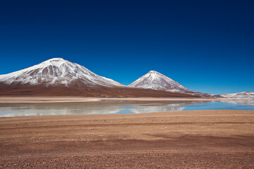Stunning snow capped mountain landscape at Bolivian Altiplano. Mountains reflecting in the lake in Bolivia