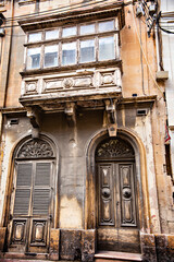Traditional Maltese architecture. Old historical houses with colorful wooden balconies in La Valetta, Malta