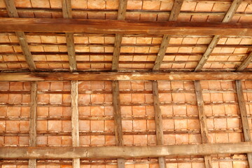 Thai style under roof of ancient building, brown wood construction and roof tiles of under roof, Thailand.