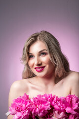 people, beauty, spa and body care concept. happy beautiful woman with pink peonies