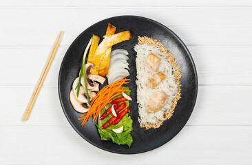 Black plate with food on white background