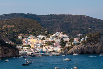 Fototapeta na wymiar View of the harbor and port at Ponza island in the summer season. The place is typical for its blue water and colo