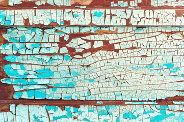 Fototapeta na wymiar Old cracked paint on a wooden wall