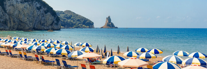 Agios Gordios beach, Corfu island, Greece. Panoramic view of the Greek beach - a long sandy sea...