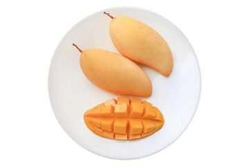 Golden mango fruit in white plate isolated on white background. Ripe yellow Barracuda mangos. Tropical fruit in thailand. Top view.