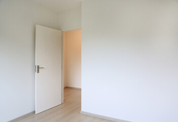 Open door in the white room of new house