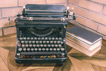 Old black typewriter  on the painted table