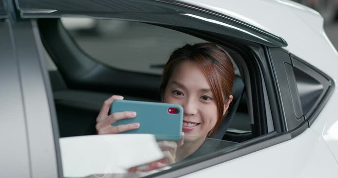 Woman use phone for take photo in car