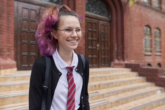 Female Student Teenager In Uniform With Backpack, Building School Background