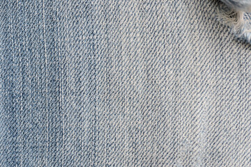 Old torn blue jeans texture close up, top view. Denim background