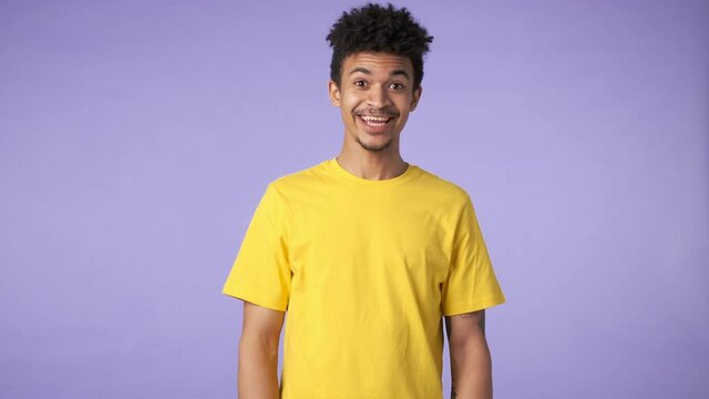 Young african positive guy isolated over purple background says yes