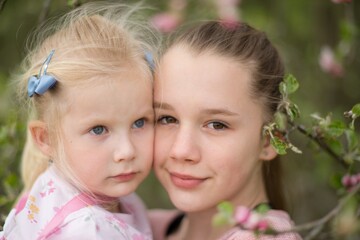 Fototapeta na wymiar Two little sisters girls on spring portrait.
