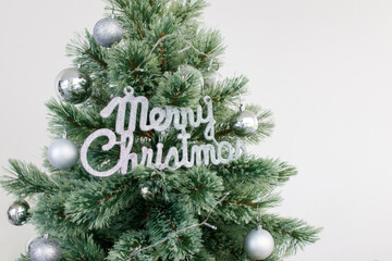 Close up Christmas tree decorated with silver ornament. Photo with copy space.