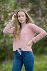 Young teenage teen girl in nature in the countryside summer portrait.