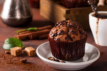 Spices, coffee and chocolate cupcakes in wooden box, close up