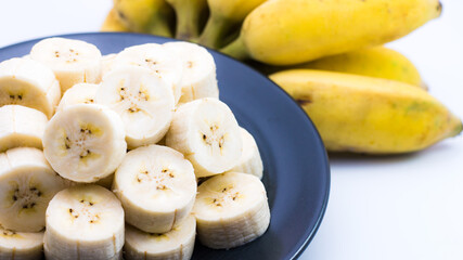 ripe cultivated banana slice in plate , sweet tropical fruit 