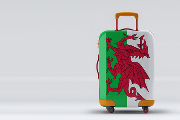 Wales flag on a stylish suitcases back view on color background. Space for text. International travel and tourism concept. 3D rendering.