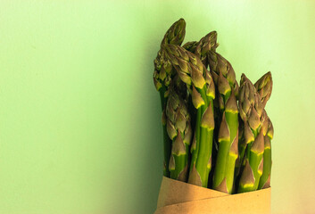 Asparagus. Fresh green asparagus on a light green clear background. 