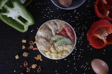 Dark food photography. Rice Bowl Recipe with eggs, chicken, and paprika. Food recipes menu idea.