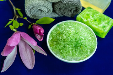 Spa composition  with towels, magnolia flowers, green salt, and soap