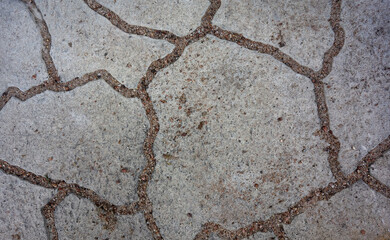 grey concrete floor tiles with sand clogged strips