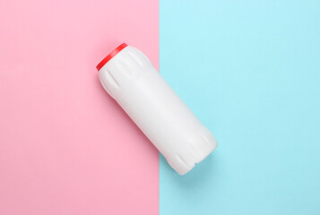 Bottle of cleaning product on blue-pink pastel background. Top view. Cleaning concept. Minimalism