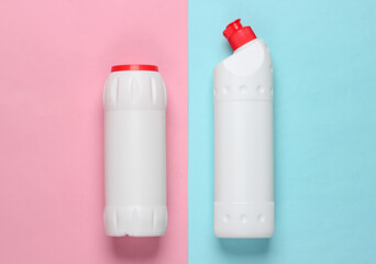 Bottles of cleaning product on blue-pink pastel background. Top view. Cleaning concept. Minimalism