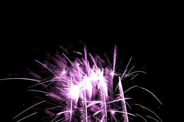 Luxury fireworks event sky show with pink glow stars. Premium entertainment magic star firework at e.g. New Years Eve or Independence Day party celebration. Black dark night background