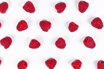 Top view of fresh ripe raspberry fruits lined up in rows on white background