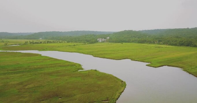 A drone shot flying over the field in Goa, India.