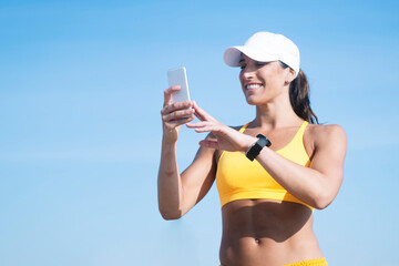 Athletic woman using her smart phone