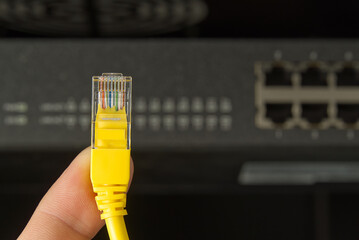 Network switch and ethernet cable in rack cabinet. Network connection technology thrue cat6 and...
