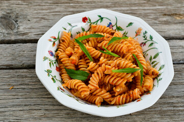  Fusilli bolognese pasta   ,fresh tomatoes and parmesan cheese.Italian home made meal. Mediterranean food concept