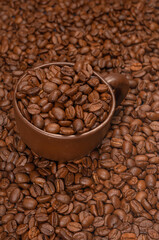 coffee cup with coffee beans on a background of coffee beans