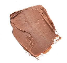 Smears of dark cream cosmetic foundation isolated on white